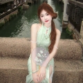 A modern Chinese-style, cool and elegant green modified cheongsam dress with a sexy and charming halter neck, perfect for summer.