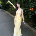 French fairy-like beach vacation maxi dress with flowing yellow tie-dye print V-neck sundress for women, summer.