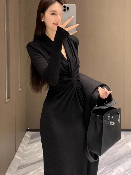 Black, stylish knitted maxi dress with a curved deep V-neck, slimming and sophisticated look. A unique long-sleeved dress for women.