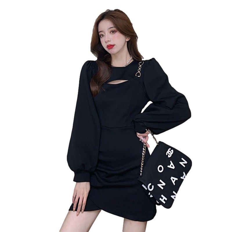 A stunning, unique, and sophisticated autumn dress with a flattering, cinched waist that's perfect for petite figures and has a sexy, subtly sexy cutout design.