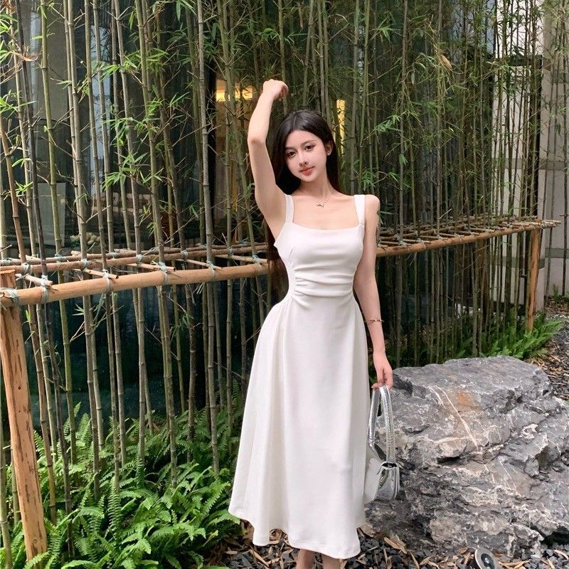 French chic and sophisticated, petite white slip dress with a cinched waist, perfect for spring and summer.