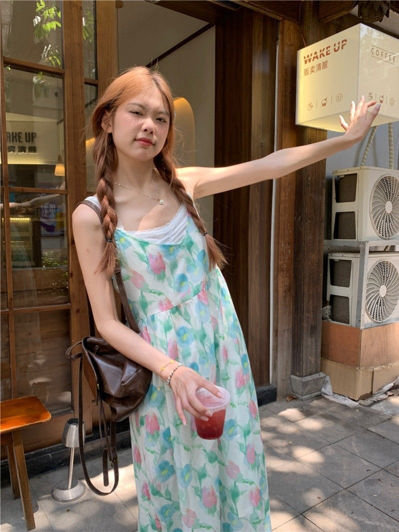 A stunningly beautiful tulip-print beach vacation dress for women, featuring a V-neck spaghetti strap design and a sweet, flowing beach style.