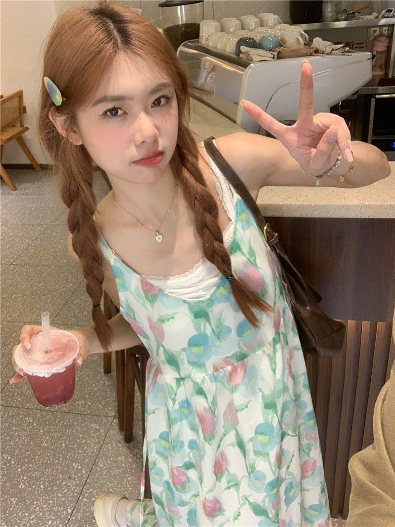 A stunningly beautiful tulip-print beach vacation dress for women, featuring a V-neck spaghetti strap design and a sweet, flowing beach style.