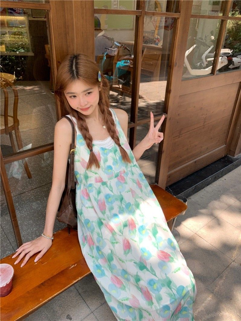 A stunningly beautiful tulip-print beach vacation dress for women, featuring a V-neck spaghetti strap design and a sweet, flowing beach style.