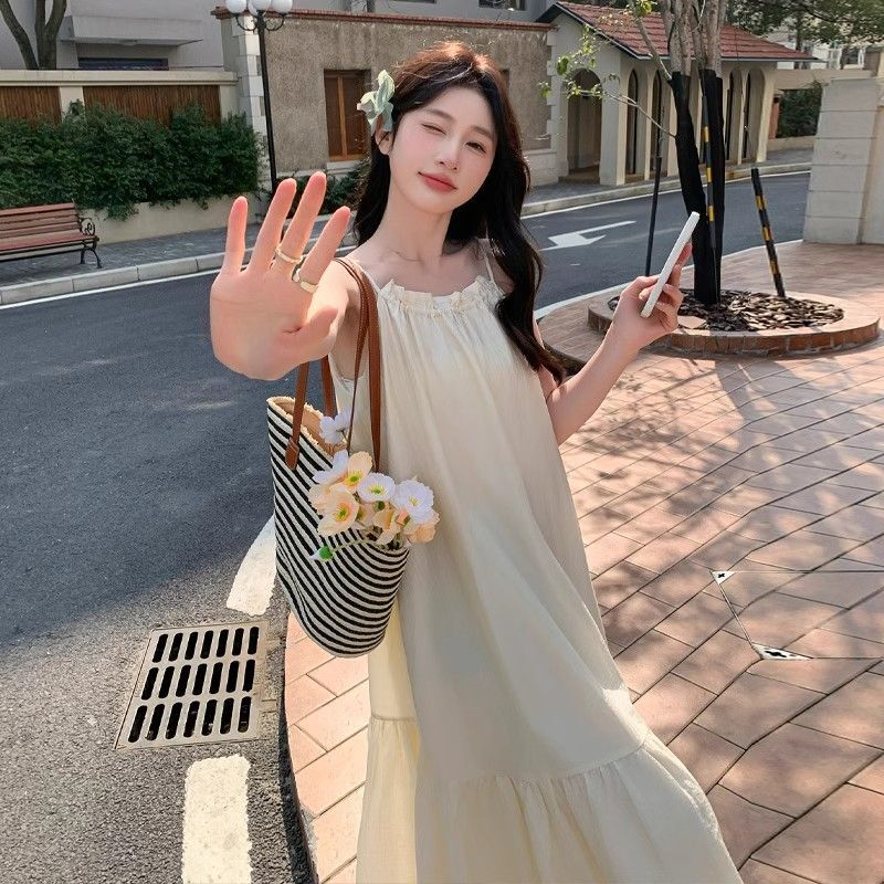 Off-white spaghetti strap dress for women, 2025 summer new style, French high-end feel, elegant and fairy-like, perfect for beach vacations.