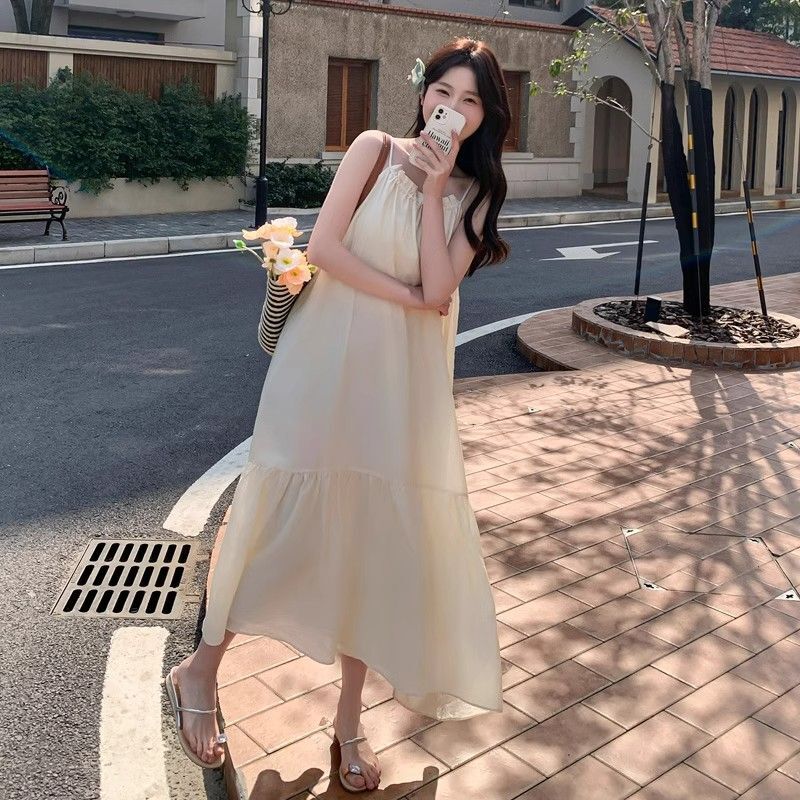 Off-white spaghetti strap dress for women, 2025 summer new style, French high-end feel, elegant and fairy-like, perfect for beach vacations.