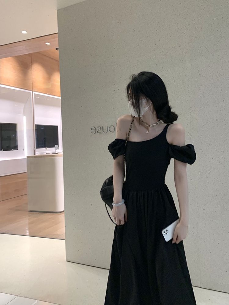 Hepburn-style black short-sleeved dress, feminine silhouette, off-shoulder design, summer 2025.