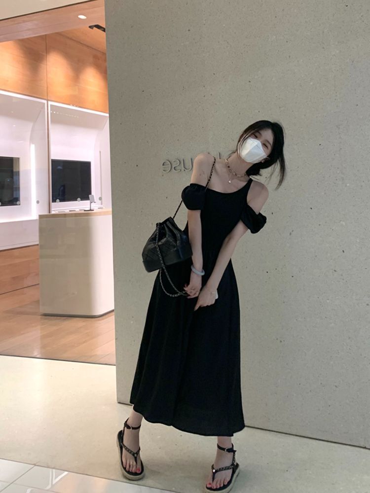 Hepburn-style black short-sleeved dress, feminine silhouette, off-shoulder design, summer 2025.